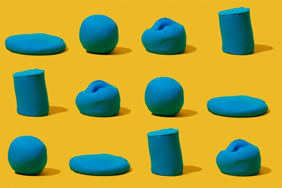 Blue lumps of clay against a yellow background