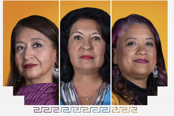 Portrait of three Latinx women with long, straight, dark hair and dark eyes; all are slightly smiling. Each person is standing in front of a orange background.