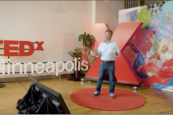 Rich Lee standing, presenting with "TedX Minneapolis" signage behind him