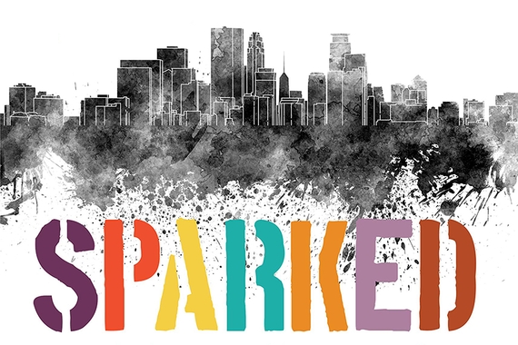 "Sparked" in colorful letters with gray watercolor skyline graphic