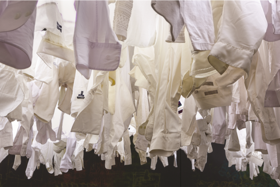 Picture of white shirts at the installation Shroud; each one representing a garment worker who died at Rana Plaza or in the Triangle Shirtwaist Factory fire