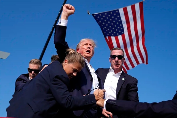 Former President Trump surrounded by US Secret Service agents at campaign rally in Pennsylvania after shots were fired.