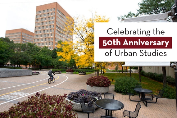 Celebrating the 50th Anniversary of Urban Studies. Photo of Social Sciences tower, biker, and tree with golden leaves in the background