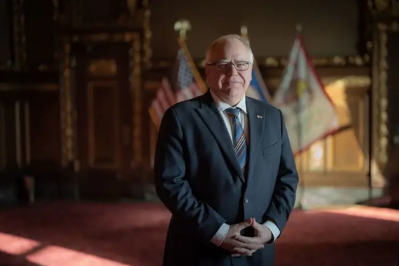 Walz standing in the Governor Reception Room with his hands clasped.