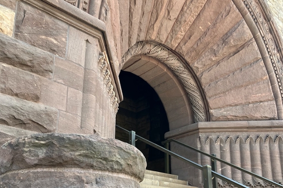 Stone archway of building, with steps and railing