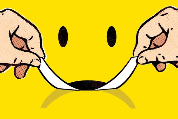 Yellow frown being turned into a smile with two hands