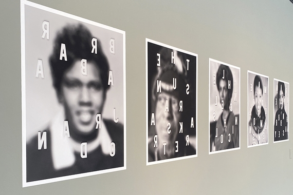 Five blurry black and white photos of famous Black Americans on a gallery wall