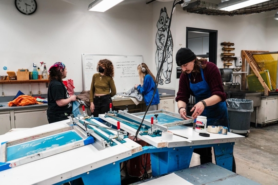 Students work in a printmaking shop