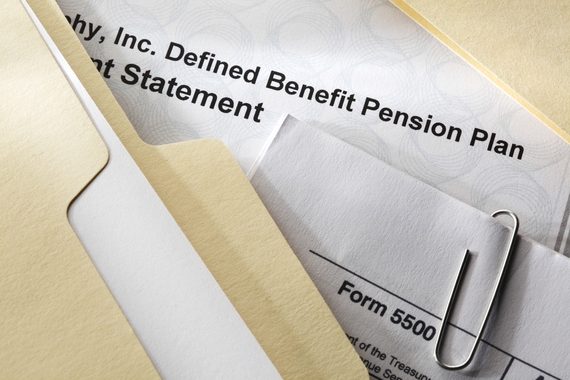 File folders and papers with text partially visible: "Defined Benefit Pension Plan Statement" and "Form 5500"