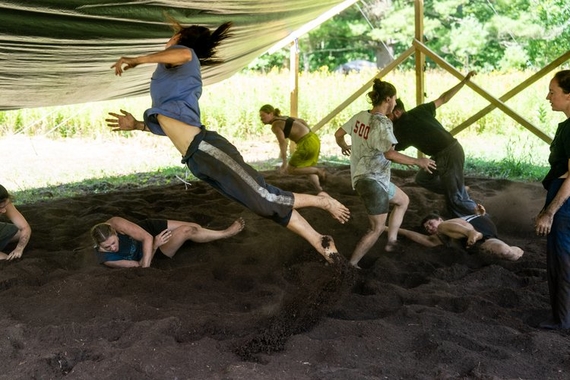 Participants jump, lie, and dance in a "battleground pit."