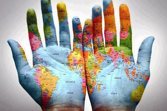 palms of two hands painted with a global map on them
