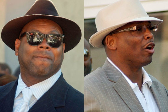James “Jimmy Jam” Harris and Terry Lewis wearing suits, fedora hats, and sunglasses