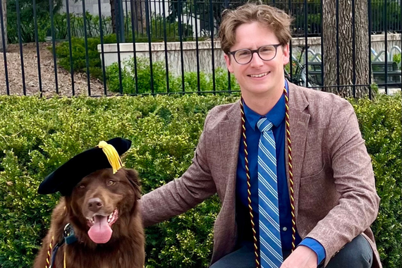 photo of student and dog wearing commencement cap