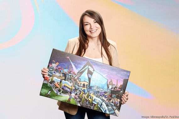 Kristen Denzer holds an abstract painting of Minneapolis