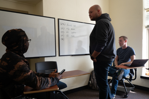 Students in the Field Methods class discuss key terms written on a whiteboard.