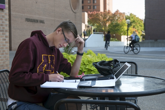 Student studying outside Ferguson Hall
