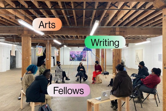 Group of people sit in a circle in an art gallery with words "Arts Writing Fellows" in bubbles above