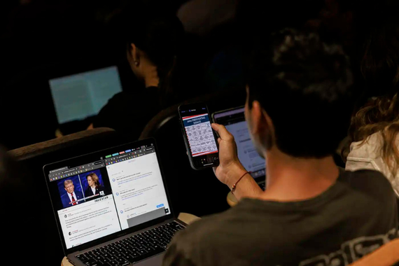 A student watches the debate between Republican presidential nominee former President Donald Trump and Democratic presidential nominee Vice President Kamala Harris, during a campus watch party at the University of Minnesota's Murphy Hall on Tuesday