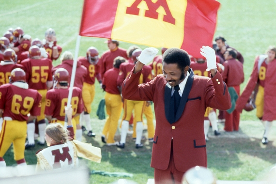 O'Neill Sanford wears a maroon suit and white gloves, conducting the Marching Band in 1977. 