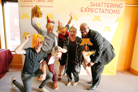 CLA staff holding celebratory props pose in front of a Shattering Expectations backdrop