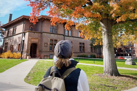 Student in front of Shevlin Hall