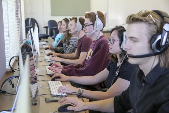 Students with headsets in a computer lab