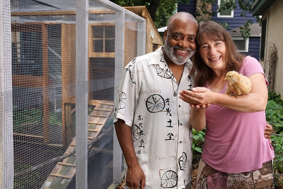 Couple standing by chicken coup