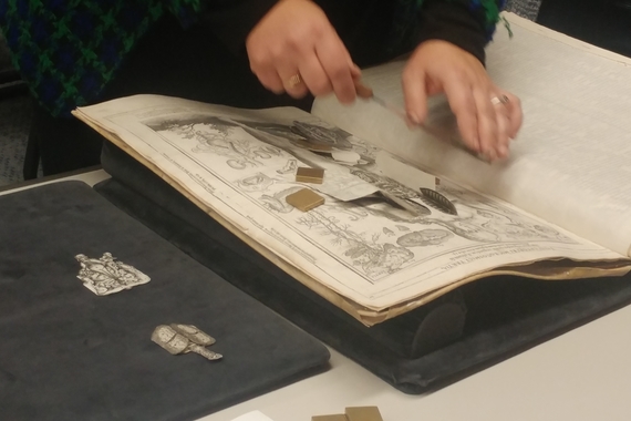 Dr. Suzanne Karr-Schmidt (Newberry Library) handles a copy of Johannes Remmelin's 17th-century flap anatomy text, "Catoptrum Microcosmicum," at the Wangensteen Library.