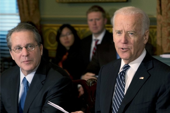 Photo of Gene Sperling sitting next to Joe Biden