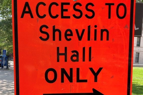 picture of a street sign that says "Access to Shevlin Hall Only with an arrow to the entrance of Shevlin hall.