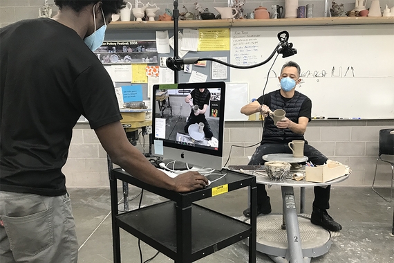 ceramics technique demo showing the student filming it from afar