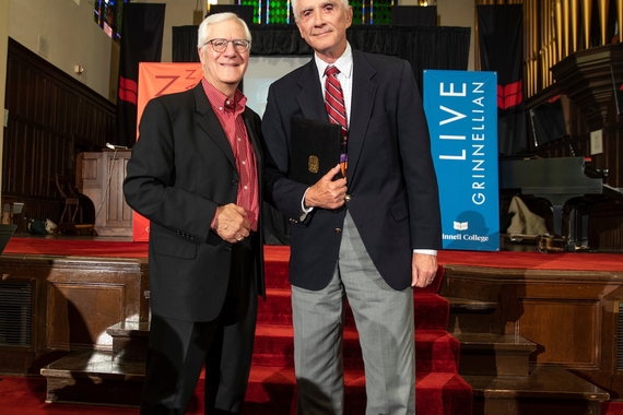 Photo showing Bruce Pauley accepting his award from Fritz Schwaller, member of the Grinnell College Alumni Council.