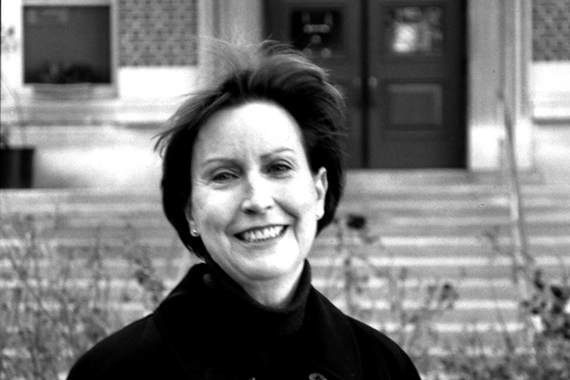 Professor Lois Cucullu in front of steps to Lind Hall; black and white photo