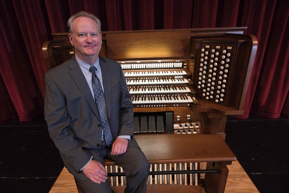 Dean Billmeyer seated in front of an organ
