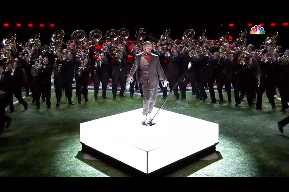 Justin Timberlake performing the Super Bowl halftime show with the U of M marching band marching behind him in formation