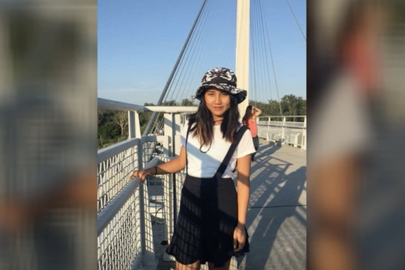 Photo of Enna standing on a bridge