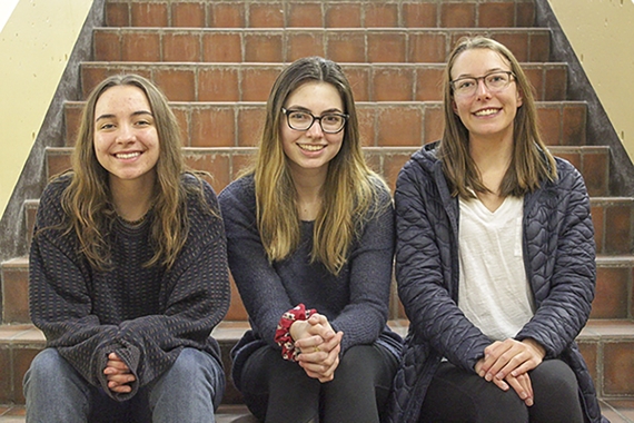 Photo of Isabella Wartzenluft, Kelsey Weddig, and Victoria Nikonov sitting together on a staircase