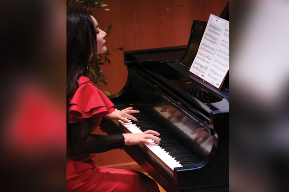 Jacqueline Beihua Fang playing a piano in concert at Ferguson Hall