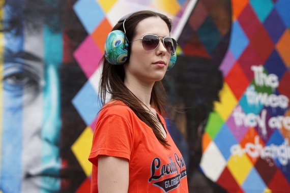 A woman at a concert dawning a pair of noise-cancelling headphones