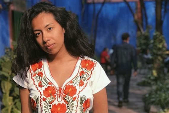 Erika Hernandez stands for a portrait in a courtyard. 