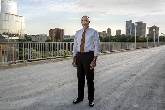 The Dean of CLA stands on the Washington avenue bridge.