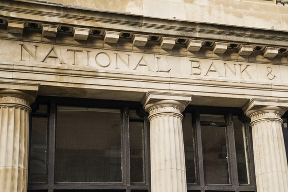 The facade of a building with pillars. It says National Bank & Trust Building