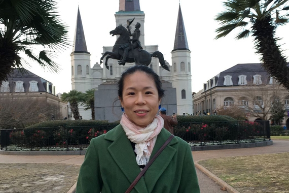 Photo of PhD candidate Bomi Jeon (head and shoulders) in front of castle, turrets, and statue of man riding horse