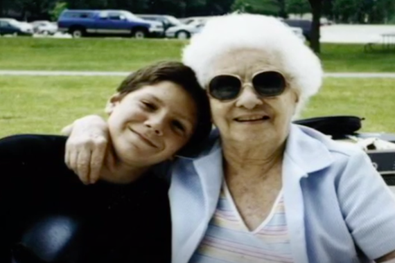 Justin as a young boy with his grandma in a park