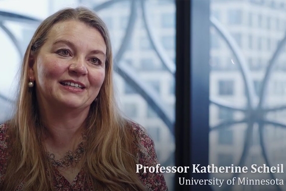 Screenshot of Professor Katherine Scheil talking in movie, head and shoulders, with identifying text in bottom right corner