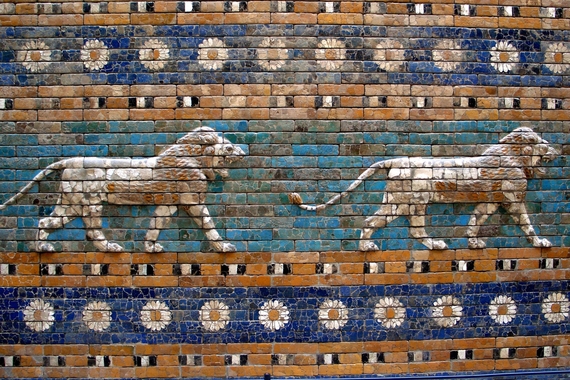 Mosaic of a lion walking in front of a teal back ground