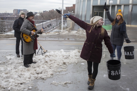 Communications professor Mark Pedelty performs harmonica with a band and University dance majors for a music video on Saturday, Jan. 20 on the Washington Avenue Bridge.