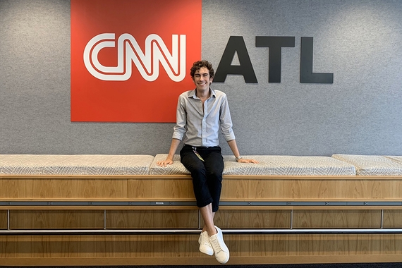 Photo of English major Dylan Miettinen in front of CNN Atlanta sign
