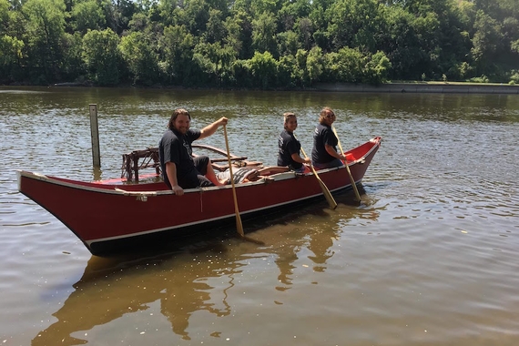 Members of the Canoe Rising Club in a canoe.