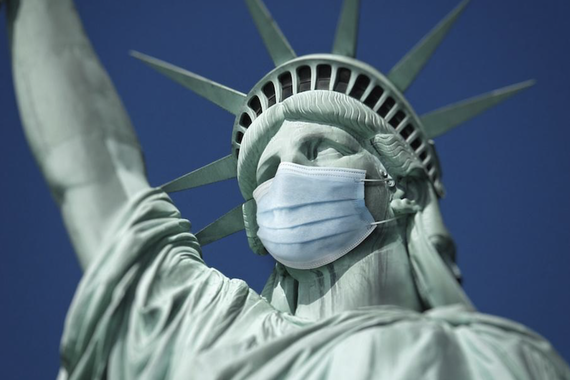 statue of liberty with protective mask on her face
